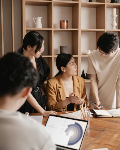 A group of professionals in a business meeting discussing data charts and strategies.
